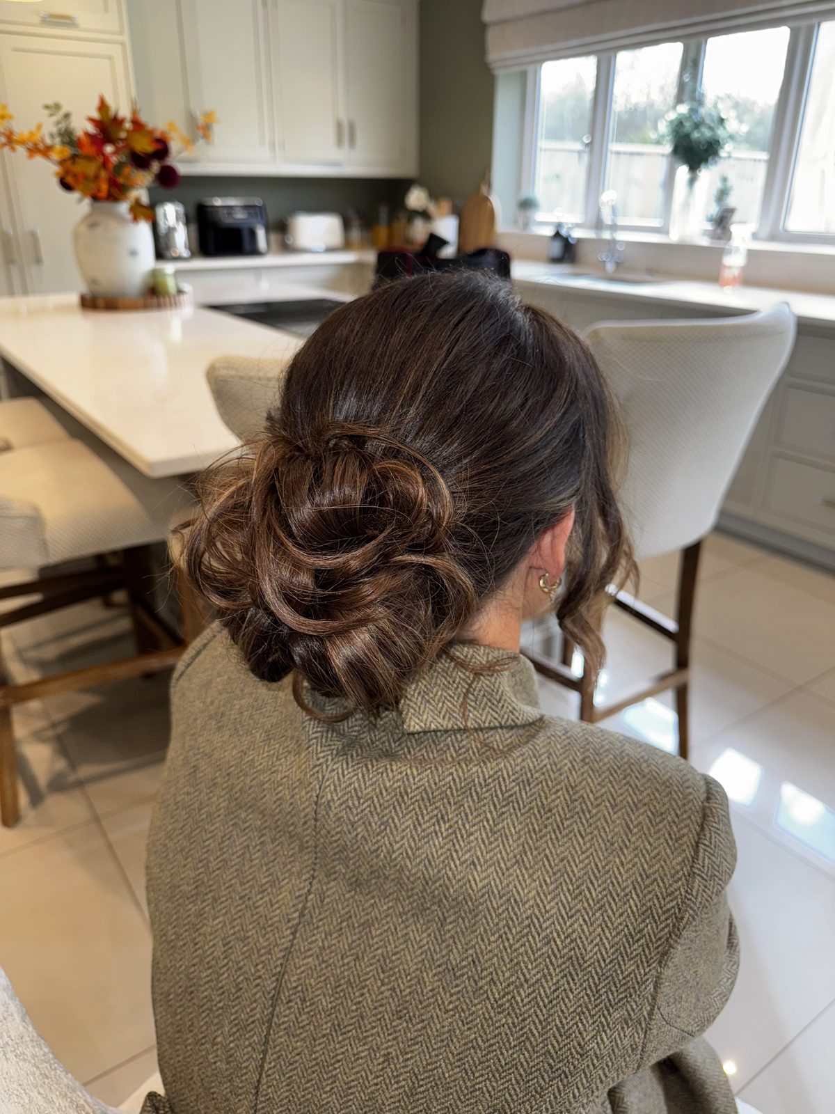 A relaxed low bun styled on location for a special occasion