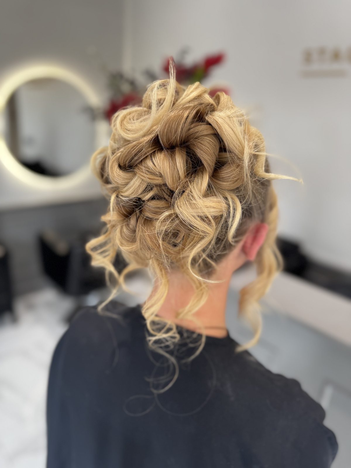 High curly prom updo with soft face-framing tendrils