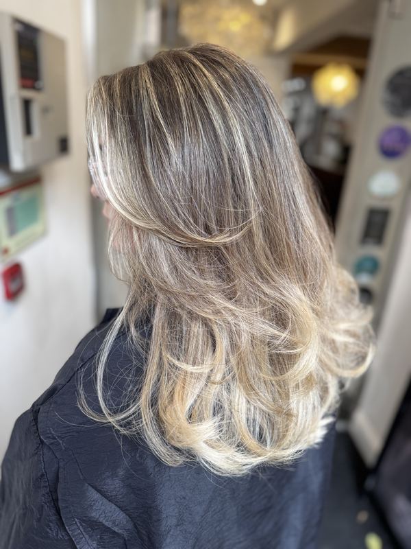 Layered blonde highlights with tousled curls