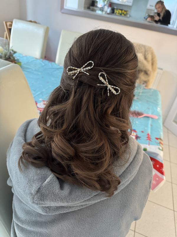 Half-up curls with sparkle bows