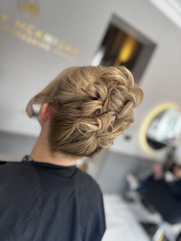 Woven updo with soft tendrils