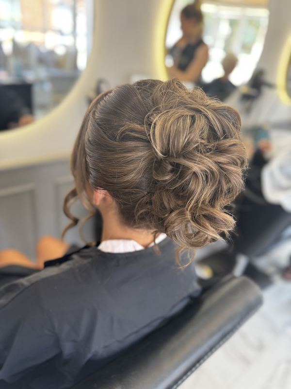 Romantic curled bun — side view